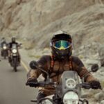 Group of motorcyclists on a daring adventure through rugged rocky roads.