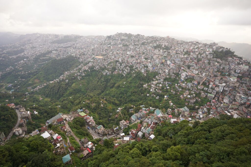 Scenic aerial view showcasing the sprawling city of Aizawl nestled among lush hills in Mizoram, India.
