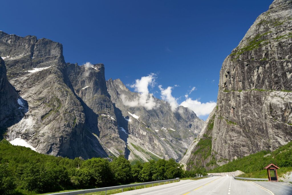 Breathtaking view of the mountains in Verma, Norway, with clear skies and a winding road.