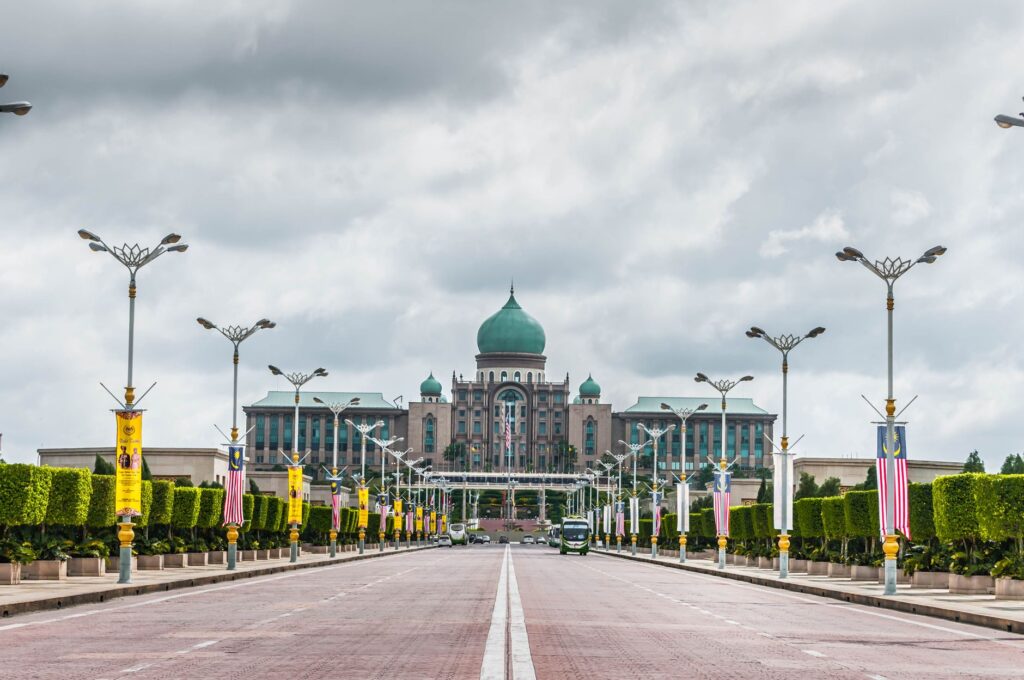 View of the Perdana Putra building, a landmark of Malaysian architecture, from a street perspective.