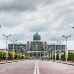 View of the Perdana Putra building, a landmark of Malaysian architecture, from a street perspective.
