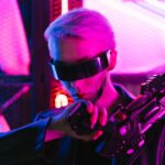 A stylish woman in cyberpunk attire poses with a futuristic gun under neon lights.
