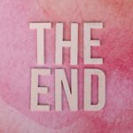 Elegant 'The End' text on a textured pink background, perfect for closure or transition concepts.