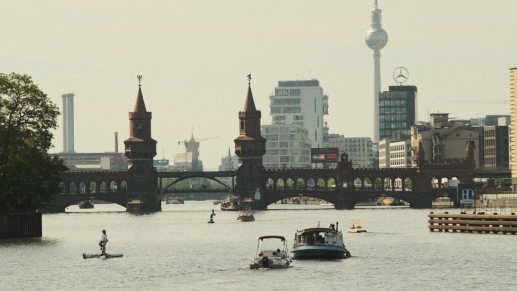A picturesque view of the Oberbaum Bridge in Berlin with boats on the river.