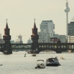 A picturesque view of the Oberbaum Bridge in Berlin with boats on the river.