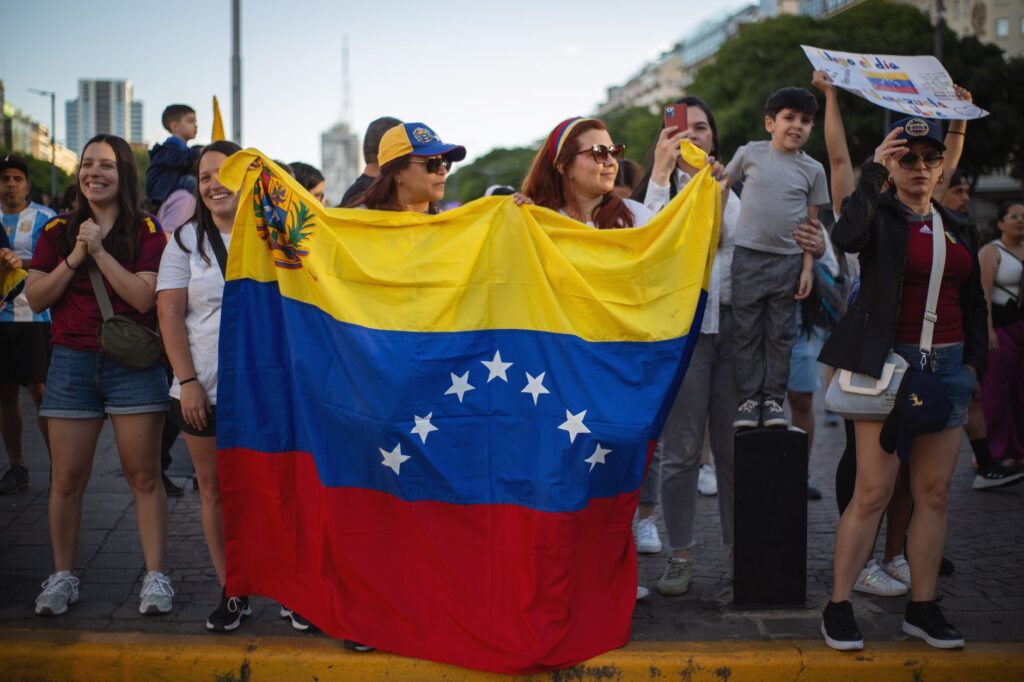 Venezuelan diaspora in Buenos Aires celebrating with national flag.