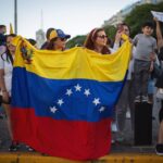 Venezuelan diaspora in Buenos Aires celebrating with national flag.