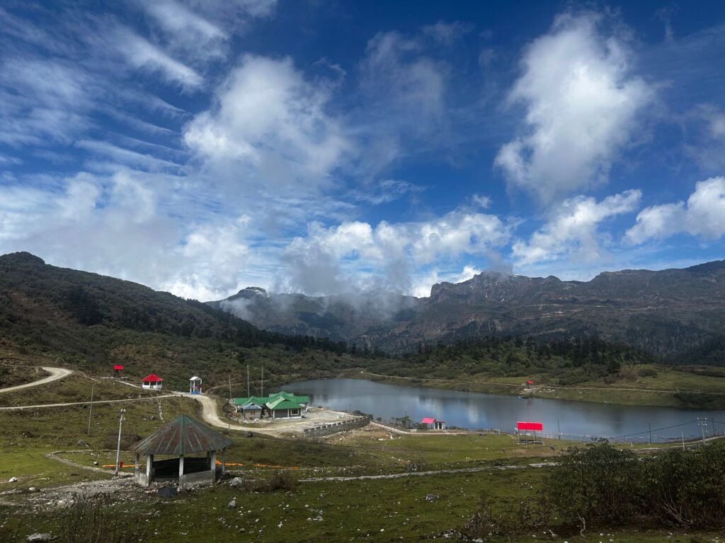 Beautiful Tawang lake and mountain landscape under a vibrant blue sky.