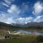 Beautiful Tawang lake and mountain landscape under a vibrant blue sky.