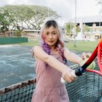 Young woman with tennis racket on an outdoor court in Southern Leyte.