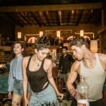 Group of young adults enjoying a lively night out at a trendy Indian bar with friends.