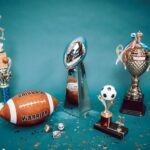 A collection of sports trophies and memorabilia representing achievement and success on a blue background.