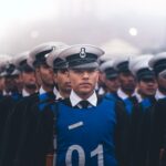 A line of uniformed military personnel marching in formation during a parade.