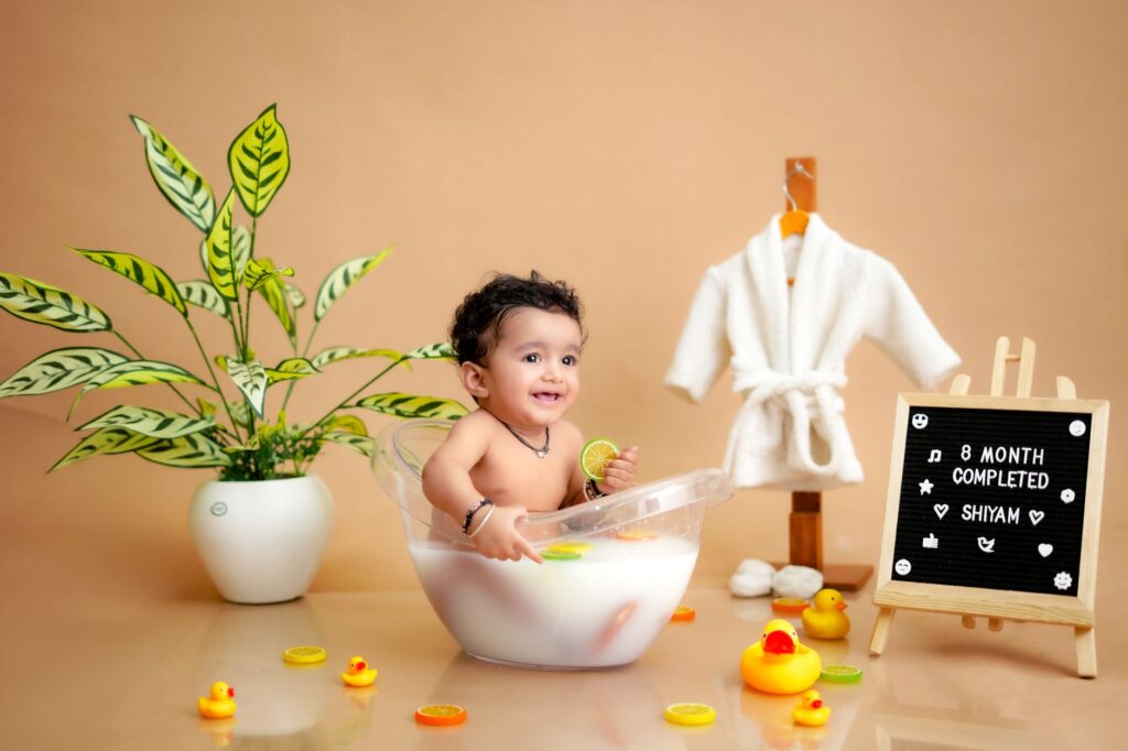 Celebrate an 8-month milestone with a cute baby enjoying a themed milk bath session.