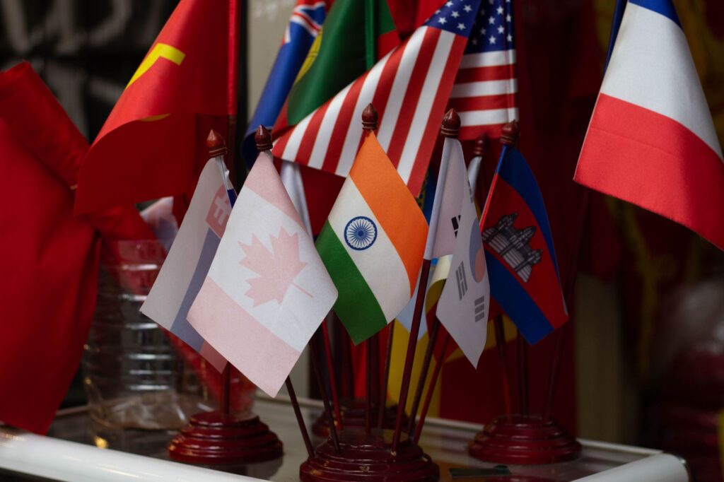 Colorful display of multiple national flags on stands, showcasing international diversity.