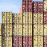 Colorful stacked shipping containers at Hamburg port, showcasing global trade and logistics.
