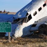 A wrecked airplane amid an open farmland, symbolizing the agricultural crash of the 1980s.
