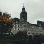 A stunning view of the Quebec City Parliament Building surrounded by autumn foliage.