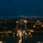 Stunning nighttime aerial cityscape of Paris highlighting iconic landmarks.