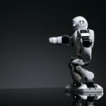 A white robot showcasing modern design on a sleek dark surface.