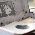 Open vintage floral suitcase with a classic photo and vinyl record inside.