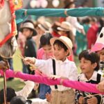 Kids interact with a horse during a lively play school event in India.