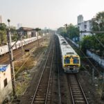 Aerial view of trains on tracks at a railway station in Mumbai, India.
