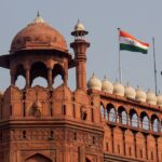 Capture of the iconic Red Fort in Delhi showcasing Mughal architecture and the Indian flag.