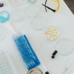 Aerial view of laboratory equipment including petri dishes, pills, test tubes, and syringes.