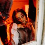 A haunting zombie emerges in a dimly lit room, evoking spine-chilling horror vibes.