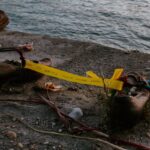 A moving memorial on the Danube riverbank in Budapest with shoes and a heartfelt message.
