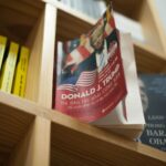 A close-up view of a bookshelf with books featuring political leaders in a bookstore setting.