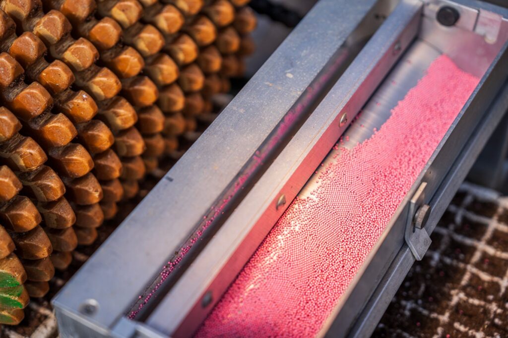 Close-up of industrial machinery with pink ball bearings and metal equipment.