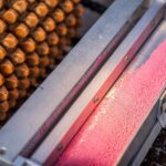 Close-up of industrial machinery with pink ball bearings and metal equipment.