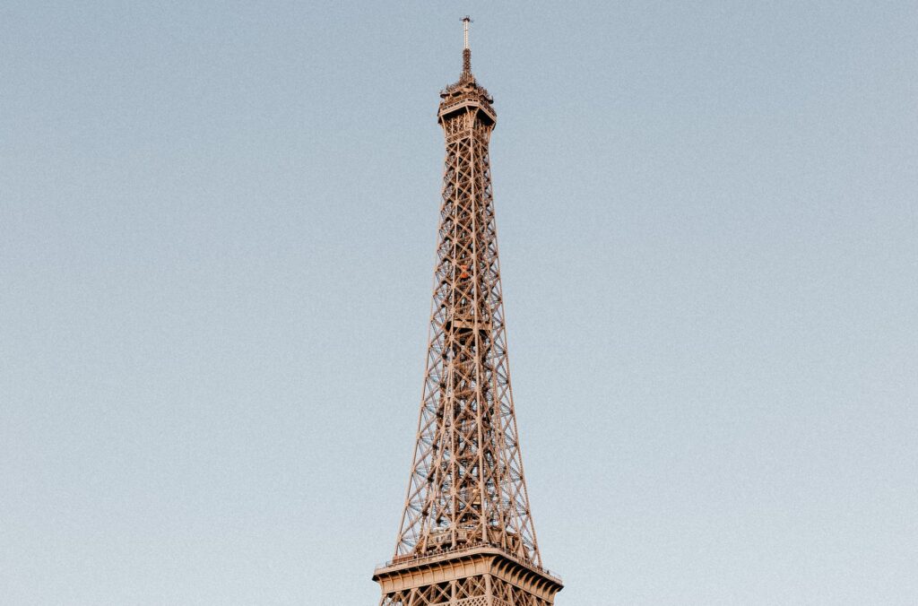 A breathtaking capture of the Eiffel Tower in Paris on a clear day, showcasing its architectural magnificence.