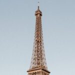 A breathtaking capture of the Eiffel Tower in Paris on a clear day, showcasing its architectural magnificence.