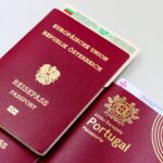 A close-up image of Austrian and Portuguese passports with a Bulgarian ID card.