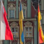 Flags of Poland, Ukraine, and Spain displayed in Wrocław's city center.