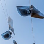 Unique installation of x-ray images suspended against a clear blue sky.