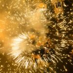 Colorful fireworks bursting in celebration during a vibrant night festival.
