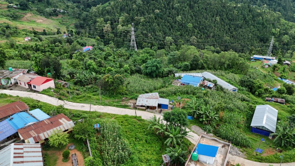 Scenic aerial view of green rural village landscape in Nepal with lush vegetation.