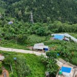 Scenic aerial view of green rural village landscape in Nepal with lush vegetation.