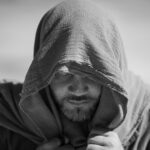 Black and white portrait of a contemplative man in a headscarf, New Port Richey.