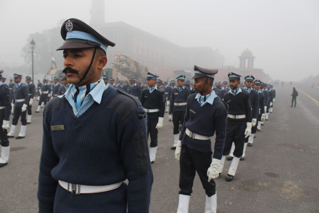 Group of soldiers marching in formation during a foggy day parade in India.