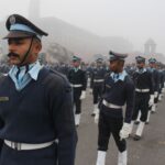 Group of soldiers marching in formation during a foggy day parade in India.