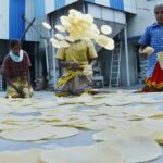Traditional papadum preparation by women in Madurai, India.