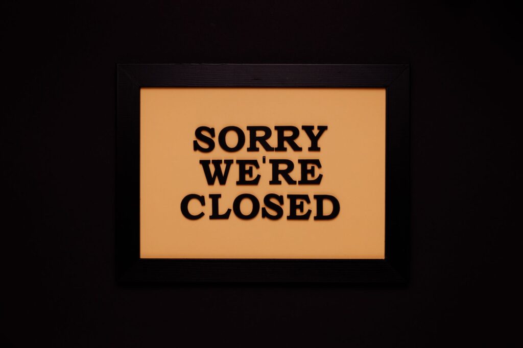 Black-framed 'Sorry We're Closed' sign against a dark backdrop, ideal for business themes.