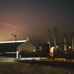 Dramatic night view of SpaceX facility with fog and lights in Brownsville, Texas.