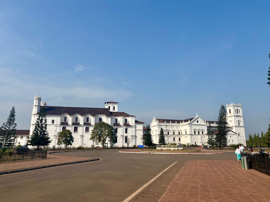 Beautiful view of Se Cathedral, a historic landmark in Old Goa, under a bright blue sky.