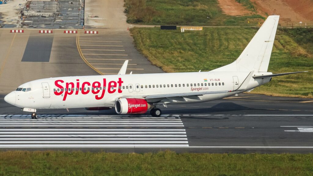 SpiceJet airplane taxiing on the runway at Dhaka Airport, Bangladesh.